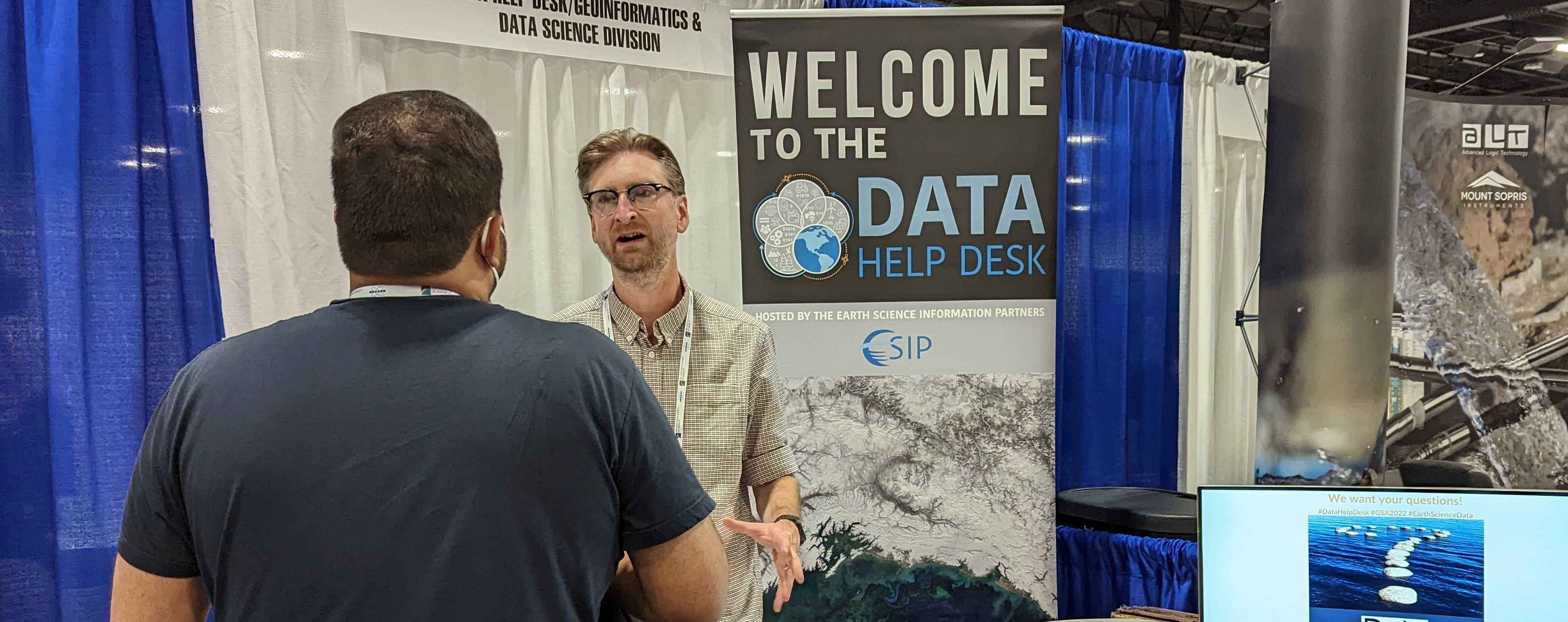 Data Help Desk table with volunteers interacting with users